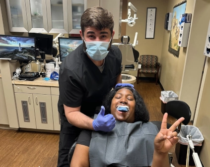 Abilene DAS student smiling with alginate impression tray during first impressions training session.